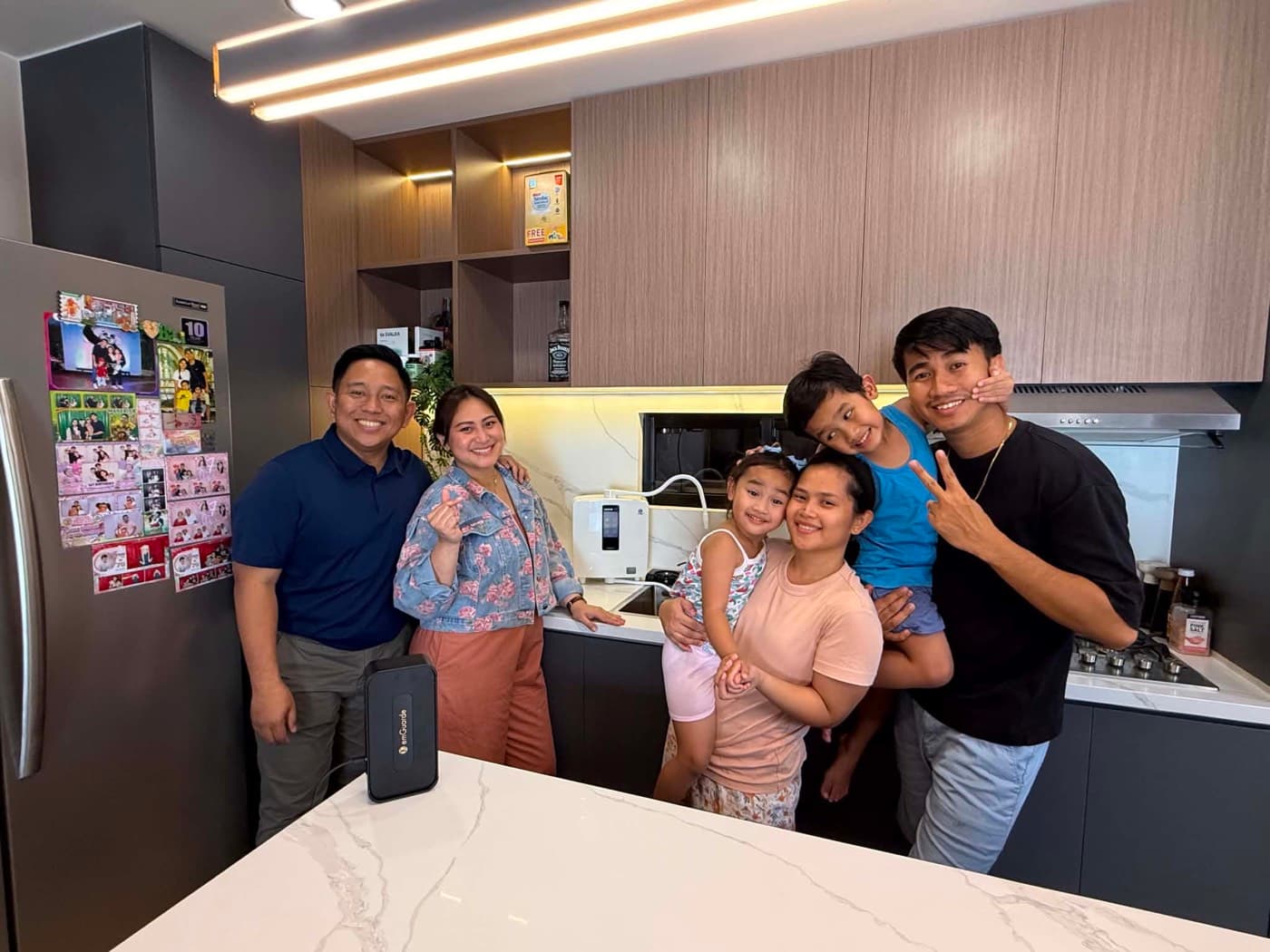 Six people behind a kitchen island with an installed Leveluk K8