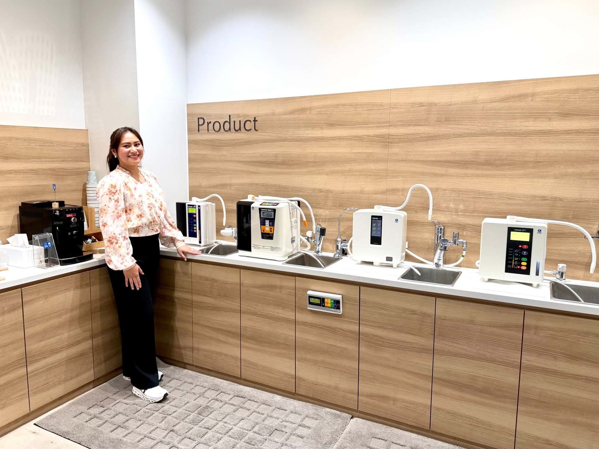 The product wall at the Enagic showroom, with four Leveluk water ionizers plumbed in at their own sinks
